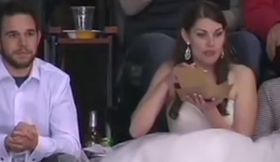 Woman In Wedding Dress Eating A Hamburger At Hockey Game Goes Viral